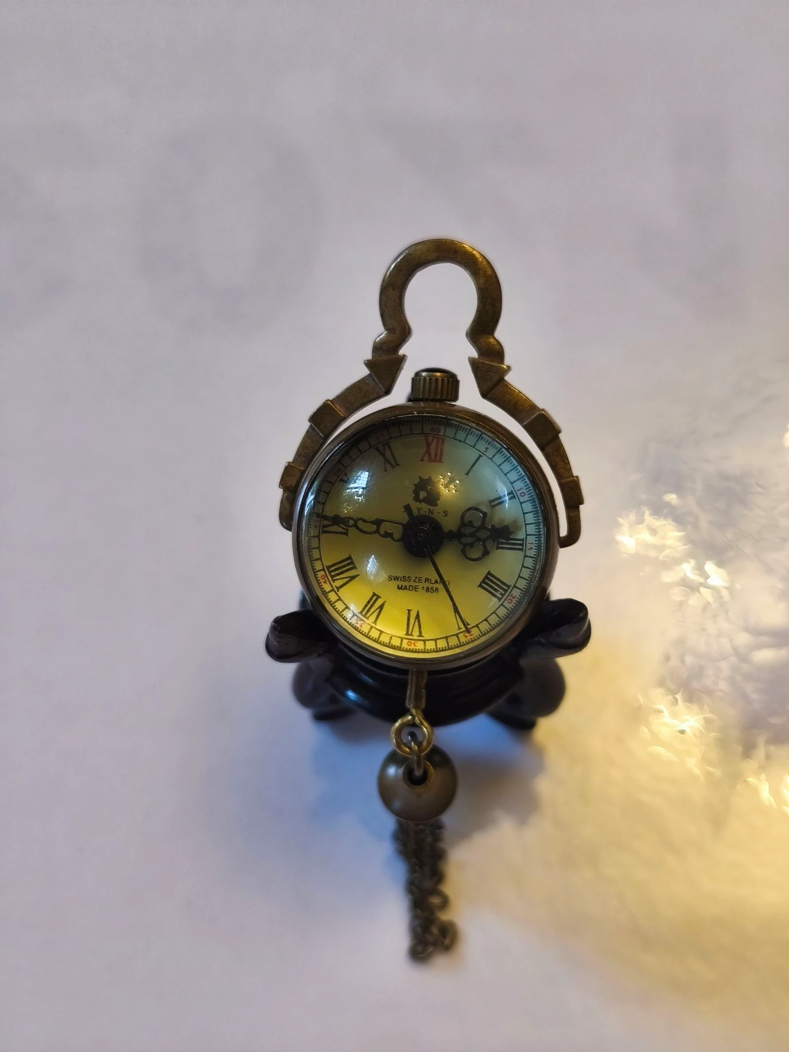 Relógio miniatura de corda antigo sobre base de madeira – photo 4